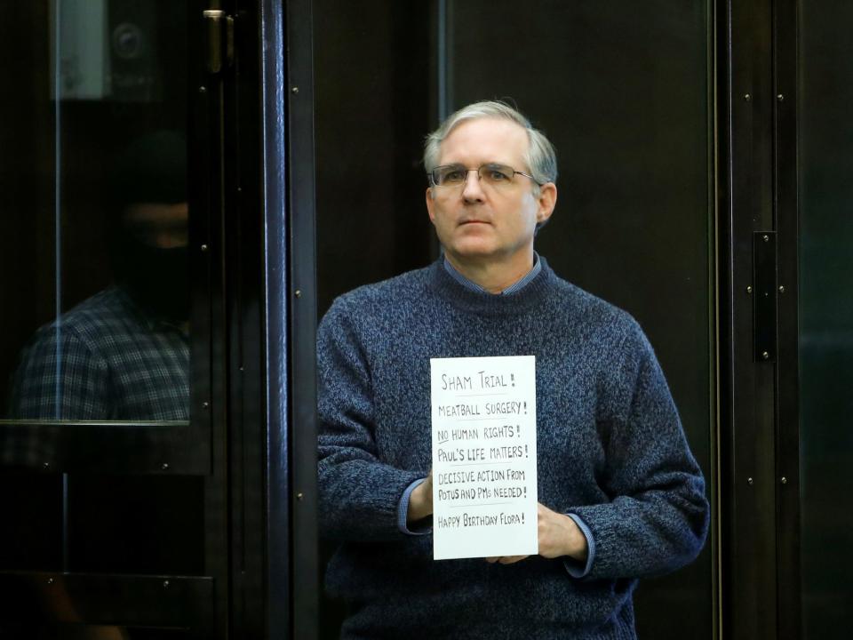 American detainee Paul Whelan holds a sign ahead of a hearing in Moscow.