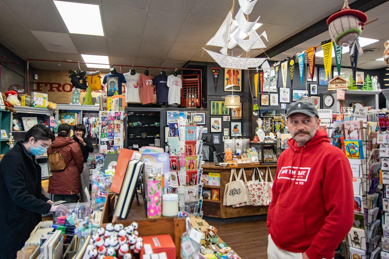 Asher Schofield, owner of Frog & Toad in Providence, stands in his store on Wednesday. He said the store is usually packed in mid-December, but business is way down since the Washington Bridge closure.