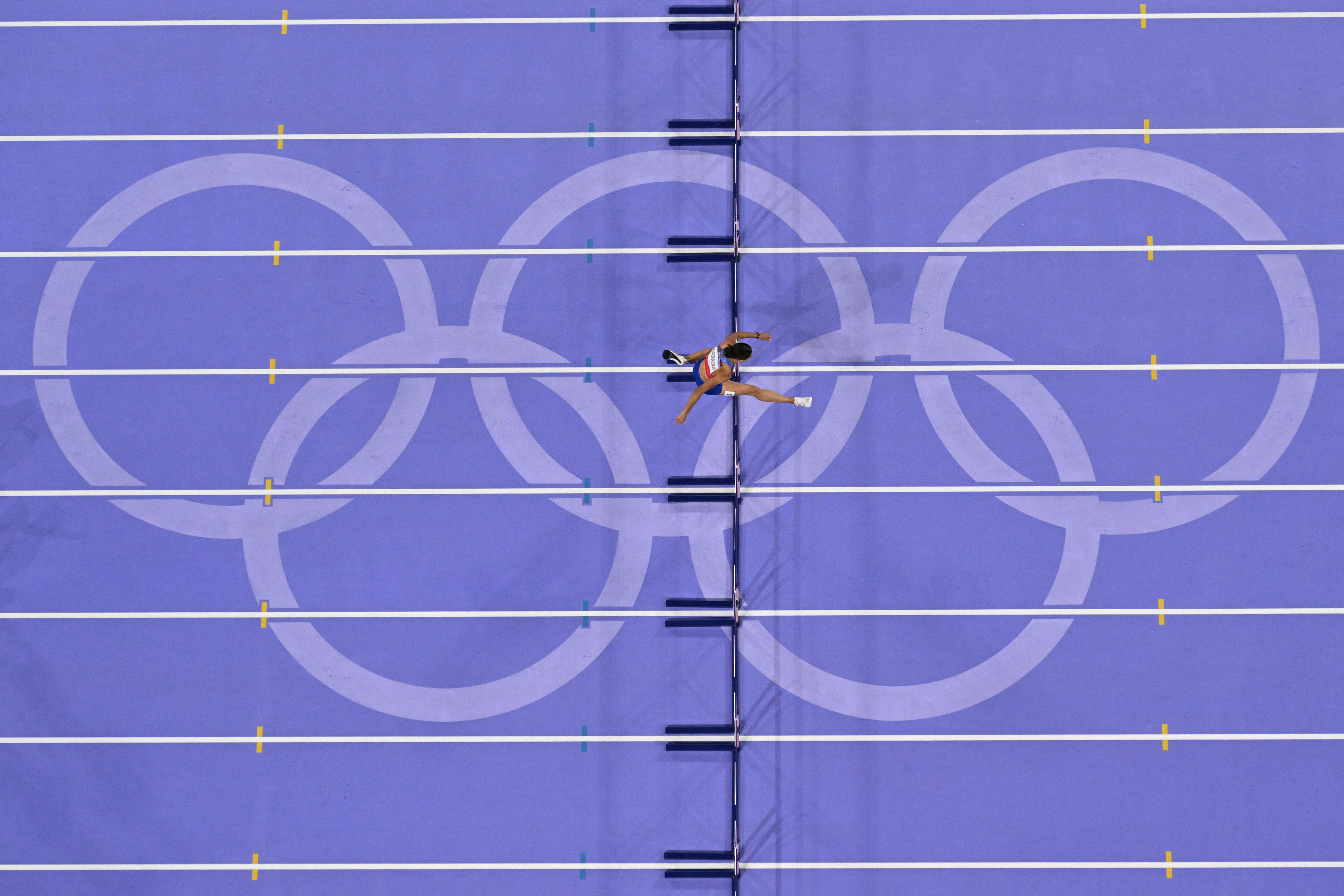 US' Sydney Mclaughlin-Levrone clears the final hurdle on her way to winning the women's 400m hurdles final of the athletics event at the Paris 2024 Olympic Games at Stade de France in Saint-Denis, north of Paris, on August 8, 2024. (Antonin Thuillier/AFP/Getty Images) 