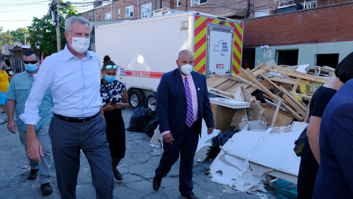 Mayor de Blasio walks past a pile of trash after President Biden visit to the East Elmhurst section of Queens destroyed by Hurricane Ida.