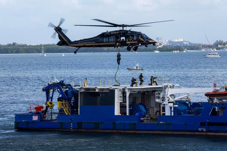 A U.S. Customs and Border Protection helicopter hovers aboard a vessel as a rescue team boards to recover sex trafficking victims during a South Florida Public Safety Regional Assets in Action Demonstration showcasing an active threat response incident in Biscayne Bay as part of the annual 2024 National Homeland Security Conference at PortMiami, Terminal J on Wednesday, July 24, 2024, in Miami, Fla.