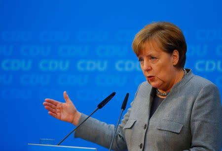 FILE PHOTO: Acting German Chancellor Angela Merkel address a news conference at the Christian Democratic Union (CDU) party headquarters in Berlin, Germany, December 18, 2017. REUTERS/Hannibal Hanschke