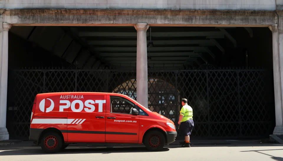 An Australia Post van is parked in a street. 