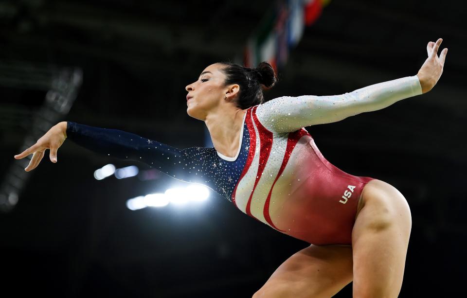 Aly Raisman competing in gymnastics wearing a Team USA leotard.