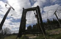 In this picture taken near the village of Kvilda, Czech Republic, on Wednesday, April 9, 2014 the reconstruction of Iron Curtain stands in the Sumava National Park. The Iron Curtain was traced by a real electrified barbed-wire fence that isolated the communist world from the West. It was an impenetrable Cold War barrier _ and for some inhabitants of the Czech Republic it still is. Deer still balk at crossing the border with Germany even though the physical fence came down a quarter century ago, with the painful Cold War past apparently still governing their behavior, new studies show. (AP Photo/Petr David Josek)