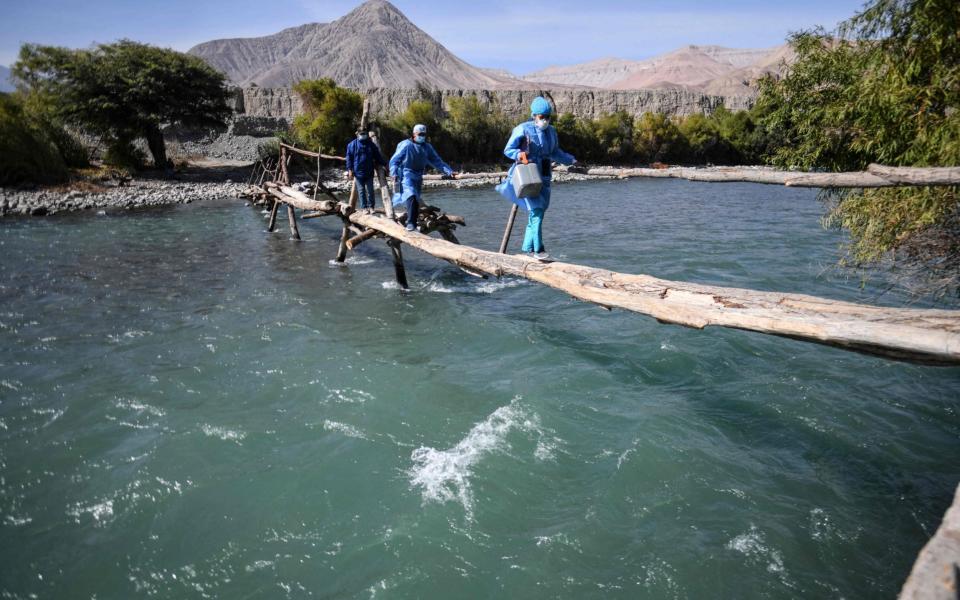 In Arequipa, southern Peru, they have to cross fast rivers on tiny, rickety bridges  - Diego Ramos/ AFP via Getty Images 