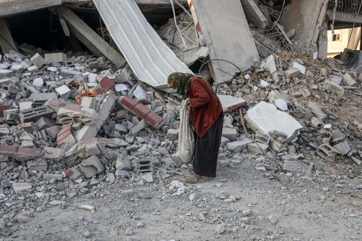 <span>Palestinians in Gaza search for wood, paper and cardboard in rubble of collapsed buildings amid ongoing Israeli attacks on Monday.</span><span>Photograph: Abed Rahim Khatib/Anadolu via Getty Images</span>