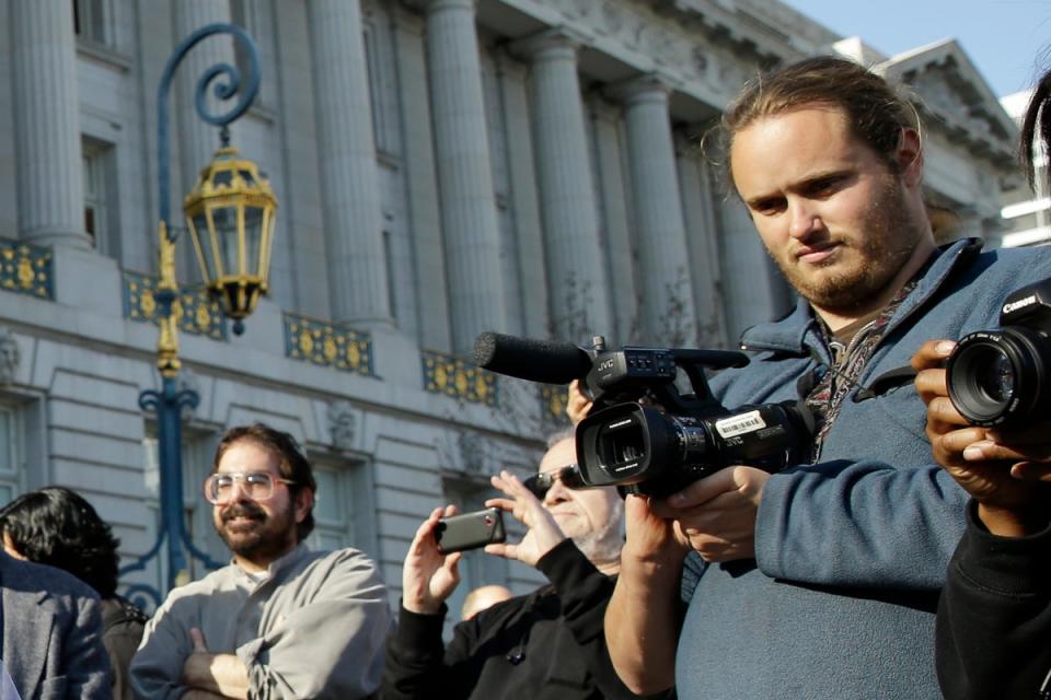 David DePape, right, records the nude wedding of Gypsy Taub outside City Hall on Dec. 19, 2013, in San Francisco (AP)