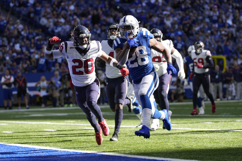 Indianapolis Colts' Jonathan Taylor (28) runs past Houston Texans' Justin Reid (20) for a touchdown during the second half of an NFL football game, Sunday, Oct. 17, 2021, in Indianapolis. (AP Photo/AJ Mast)