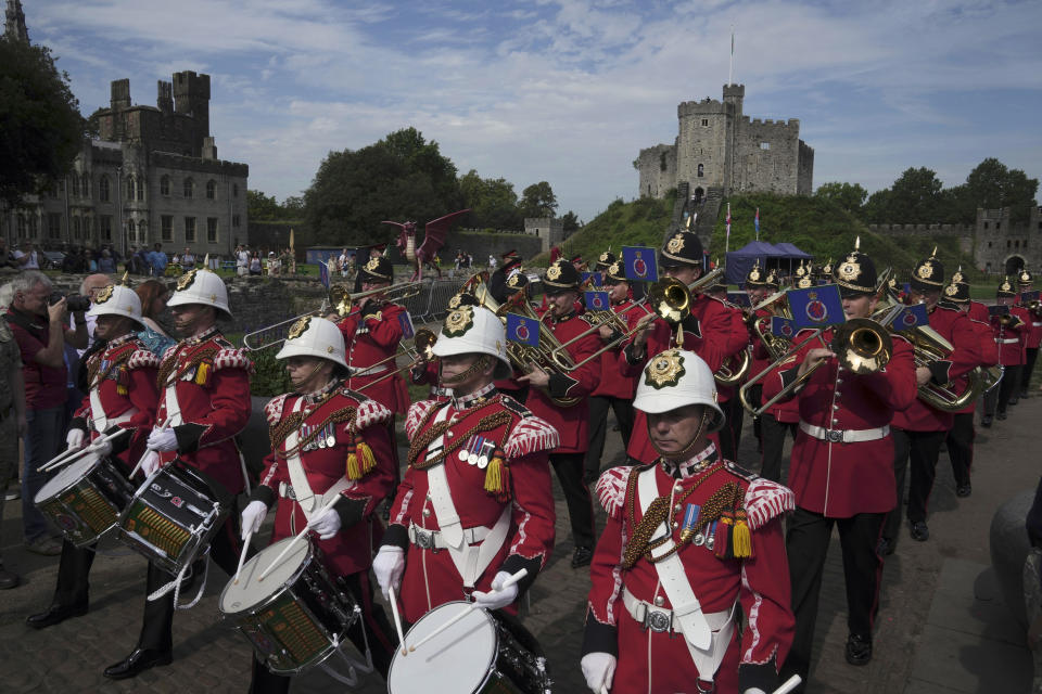 Royal Band march to mark the First anniversary of the death of Queen Elizabeth II, in Cardiff Castle, Wales, Friday, Sept. 8, 2023. With gun salutes is marking the first anniversary of the death of Queen Elizabeth II and the ascension of King Charles III, who remembered his mother as a symbol of stability during her 70-year reign. (AP Photo/Kin Cheung)