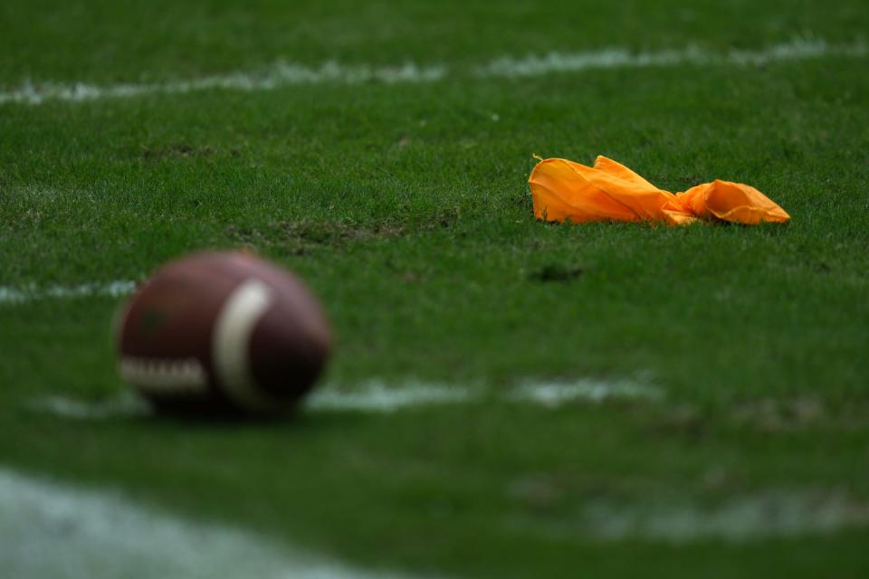 A general view of a penalty flag and football on the field during the second half between the Miami Hurricanes and the Michigan State Spartans at Hard Rock Stadium in Miami Gardens, Fla. on Sept. 18, 2021.