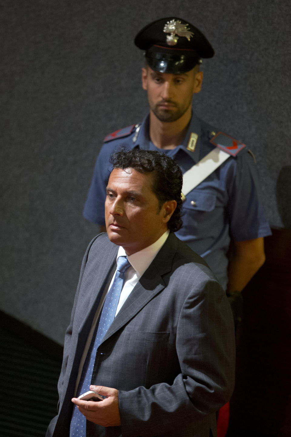 Captain Francesco Schettino arrives in the court room of the converted Teatro Moderno theater for the start of his trial, in Grosseto's Teatro Moderno, Italy, Wednesday, July 17, 2013. The trial of the captain of the shipwrecked Costa Concordia cruise liner, accused of multiple manslaughter, abandoning ship and causing the shipwreck near the island of Giglio, has begun in a theater converted into a courtroom in Tuscany to accommodate all the survivors and relatives of the 32 victims who want to see justice carried out in the 2012 tragedy. The trial, which was supposed to get under way July 9, was postponed until Wednesday due to a lawyers' strike. (AP Photo/Andrew Medichini)