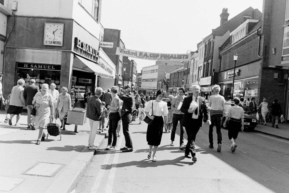 Some shoppers turn round to look at the banner 40 years ago today <i>(Image: Watford Observer)</i>