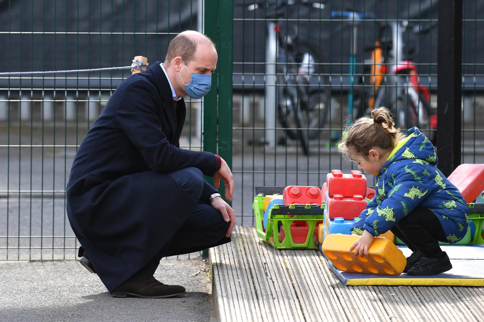 LONDON, ENGLAND - MARCH 11: Prince William, Duke of Cambridge, speaks to a young pupil in the playground during a visit to School 21 in Stratford on March 11, 2021 in London, England. The Duke and Duchess of Cambridge visited the school in east London to congratulate teachers involved in the re-opening of the school following lockdown restrictions. (Photo by Justin Tallis - WPA Pool/Getty Images)