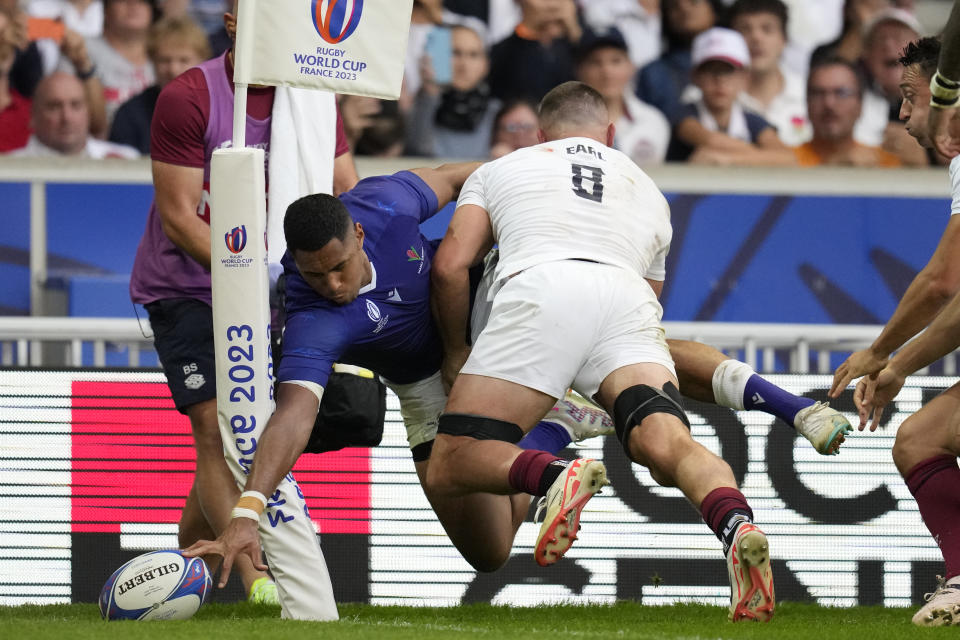 Samoa's Nigel Ah Wong is tackled by England's Ben Earl as he tries to score during the Rugby World Cup Pool D match between England and Samoa at the Stade Pierre Mauroy in Villeneuve-d'Ascq, outside Lille, France, Saturday, Oct. 7, 2023. (AP Photo/Themba Hadebe)