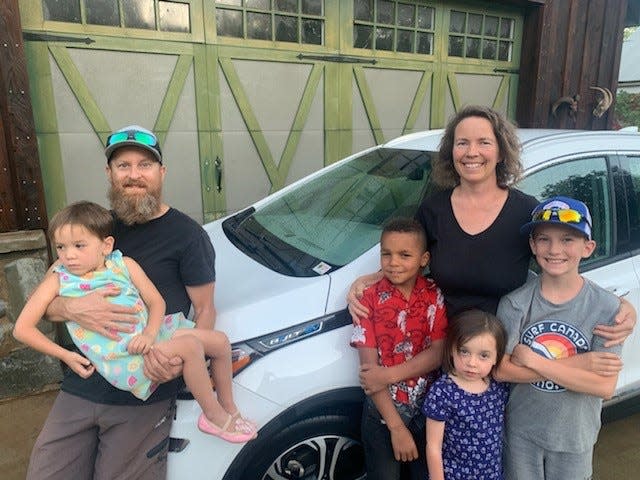 The Gardner family with their 2019 Chevrolet Bolt that GM has promised to buy back as part of a recall for potential fire risk. The family lives in Northern California near the wild fires. From left to right: Nathan Gardner holding Sammy Gardner, Jonathan Gardner (red shirt), Lily Gardner, Carver Gardner and Tracy Gardner (black shirt).