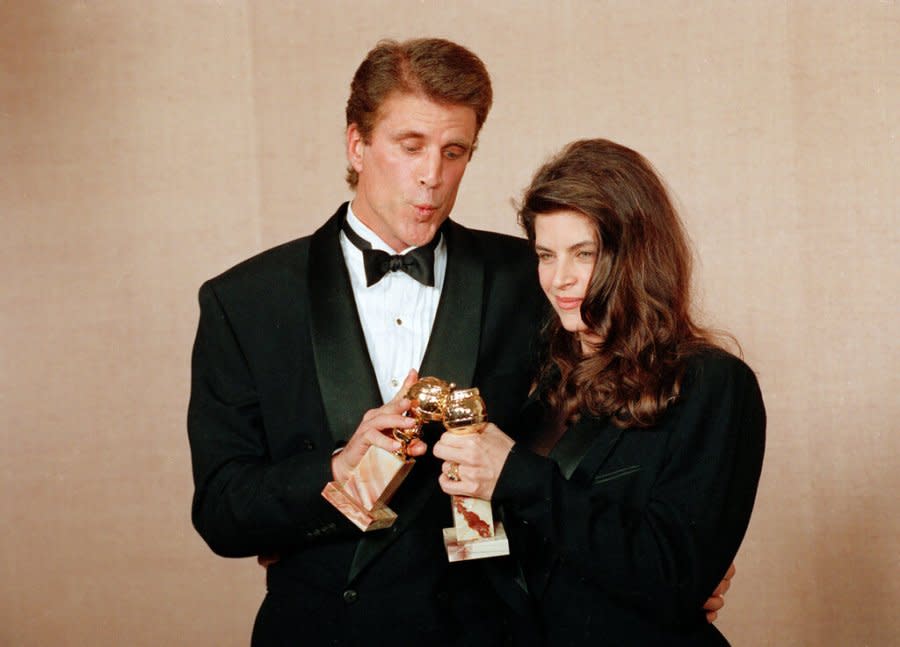 Actors Ted Danson and Kirstie Alley touch their awards together backstage at the 48th Annual Golden Globe Awards in Beverly Hills, Calif., Jan. 19, 1991. Danson and Alley won for best actor and best actress in a television comedy for their work on “Cheers.” (AP Photo/Doug Pizac)