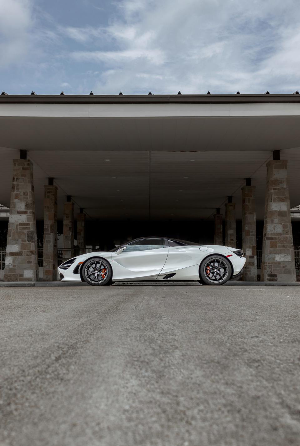 The McLaren 720S Spider under a dark awning.