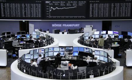 Traders are pictured at their desks in front of the DAX board at the Frankfurt stock exchange May 26, 2014. REUTERS/Remote/Stringer