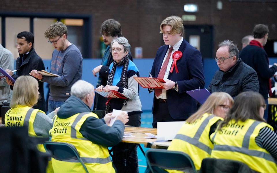 Party officials observe the count during the count at Northgate Arena Leisure Centre - PA