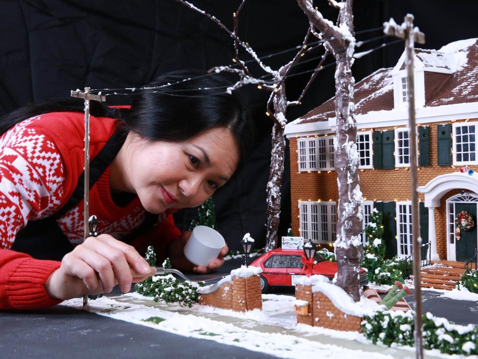 Cake designer Michelle Wibowo works on her gingerbread version of the McCallister house
