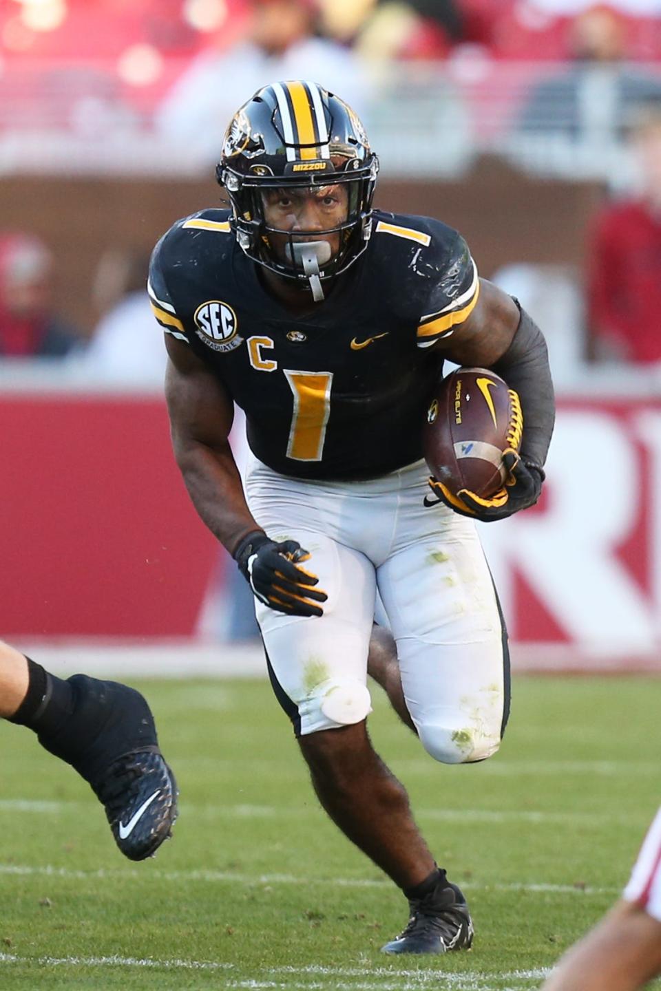 Missouri Tigers running back Tyler Badie (1) rushes the ball against the Arkansas Razorbacks this season at Donald W. Reynolds Razorback Stadium in Fayetteville, Ark.