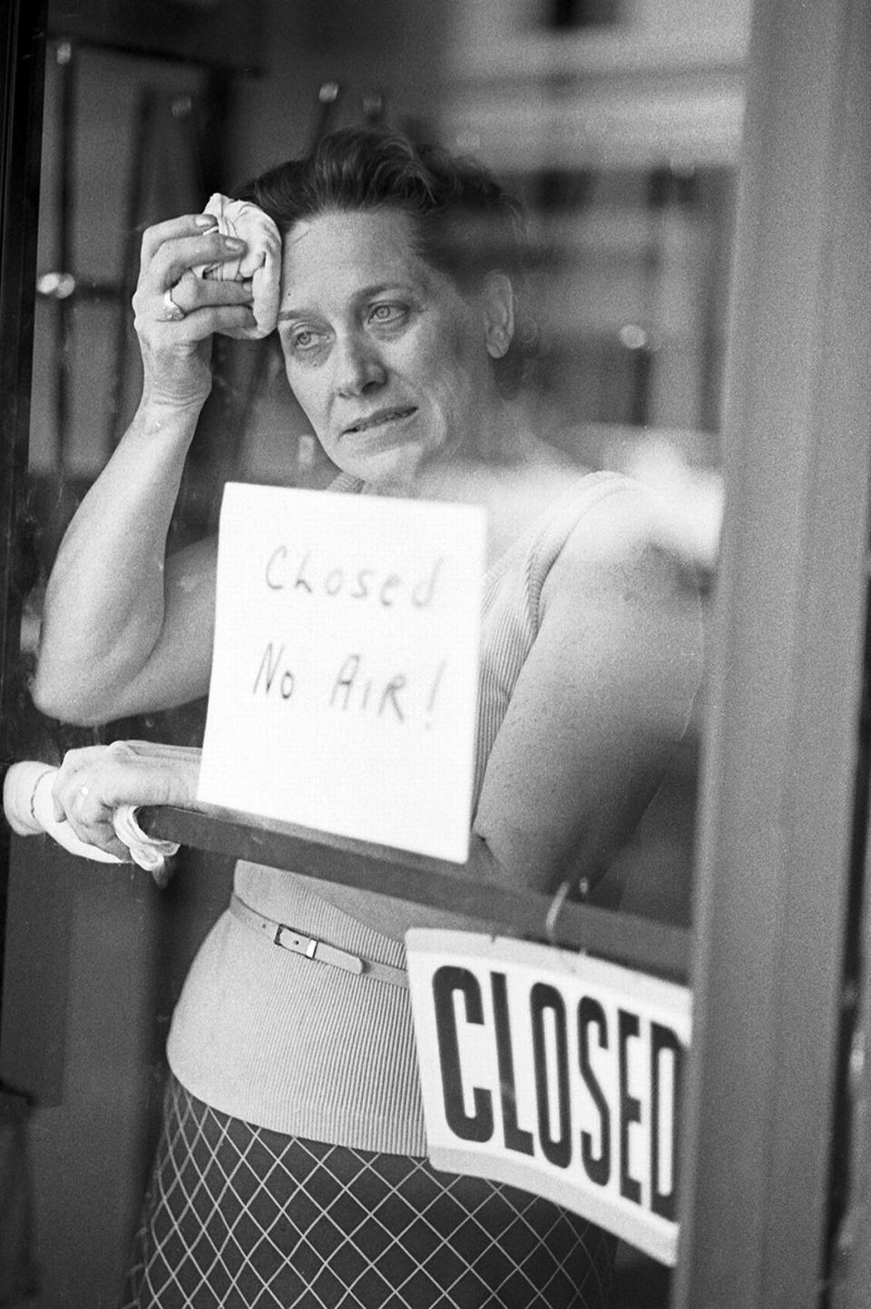 June 26, 1980: Maxine Harkridge, owner of Rusty’s Hot Dogs, stands next to a sign reading “Closed, no air!” and wipes sweat off her brow while waiting for the air conditioning repair person. Vince Heptig] Vince Heptig/Fort Worth Star-Telegram archive/UT Arlington Special Collections