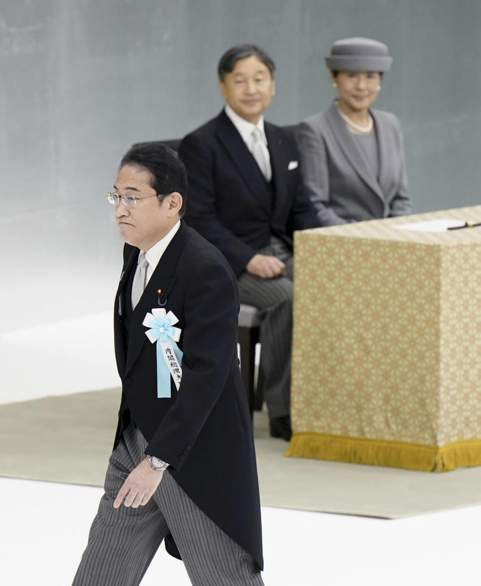 Japanese Prime Minister Fumio Kishida, front, prepares to deliver a speech as Emperor Naruhito, left, and Empress Masako, right, look on during the memorial ceremony for the war dead at the Nippon Budokan hall in Tokyo, Tuesday, Aug. 15, 2023. Japan held the annual memorial service for the war dead as the country marks the 78th anniversary of its defeat in the World War II.(Kyodo News via AP)