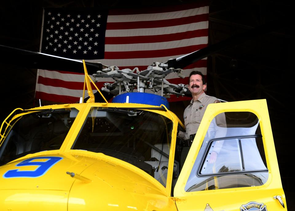 Ventura County Sheriff Bill Ayub stands in doorway of the agency's new Bell 412EPX helicopter at the Ventura County Aviation Unit in Camarillo on Thursday, Dec. 22, 2022. Ayub advocated for the new helicopter and considers its purchase one of his top achievements.