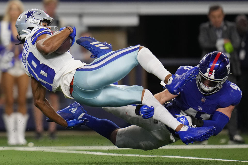 Dallas Cowboys wide receiver Jalen Tolbert (18) is hit by New York Giants linebacker Micah McFadden (41) in the second half of an NFL football game, Sunday, Nov. 12, 2023, in Arlington, Texas. (AP Photo/Julio Cortez)
