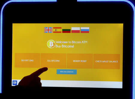 A man touches a screen of a bitcoin ATM in Vilnius, Lithuania December 6, 2017. REUTERS/Ints Kalnins