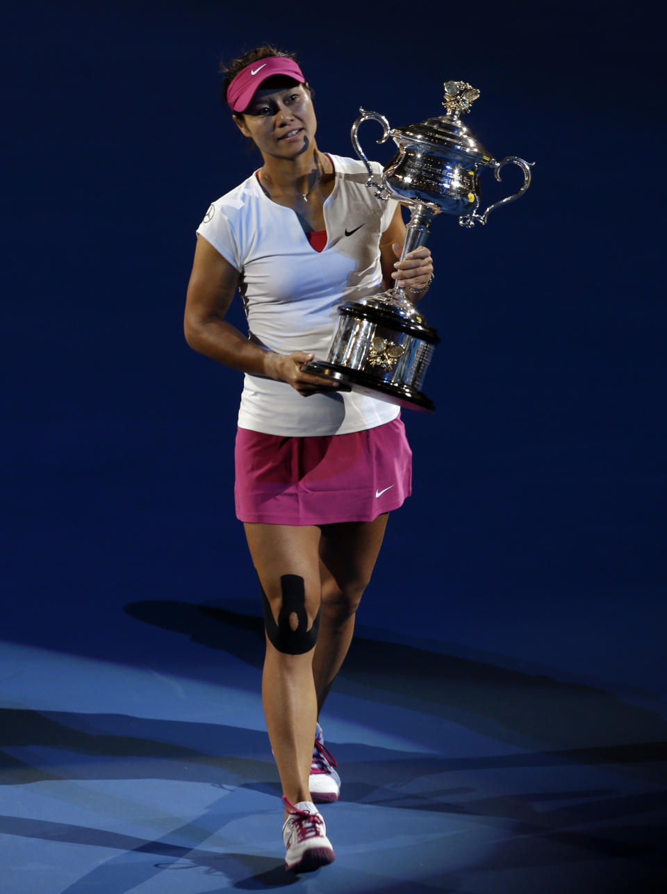 Li Na of China holds the championship trophy after defeating Dominika Cibulkova of Slovakiaduring their women's singles final at the Australian Open tennis championship in Melbourne, Australia, Saturday, Jan. 25, 2014.(AP Photo/Aijaz Rahi)