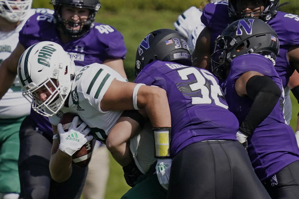 Ohio tight end Ryan Luehrman, left, is tackled by Northwestern linebacker Bryce Gallagher, center, and safety Brandon Joseph during the first half of an NCAA college football game in Evanston, Ill., Saturday, Sept. 25, 2021. (AP Photo/Nam Y. Huh)
