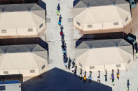 <p>Immigrant children, many of whom have been separated from their parents under a new “zero tolerance” policy by the Trump administration, walk in single file between tents in their compound next to the Mexican border in Tornillo, Texas, June 18, 2018. (Photo: Mike Blake/Reuters) </p>