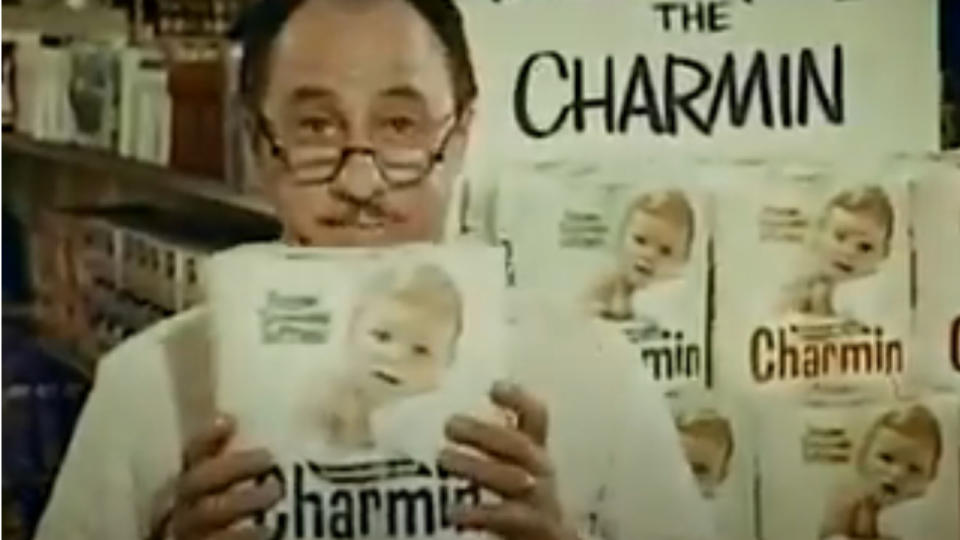 Dick Wilson holds a package of toilet paper protectively for Charmin.