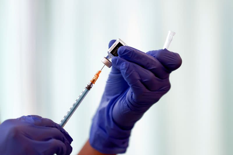 FILE PHOTO: FILE PHOTO: A medical worker fills a syringe with a dose of the Pfizer-BioNTech coronavirus disease (COVID-19) vaccine as Japan launches its inoculation campaign, at Tokyo Medical Center in Tokyo