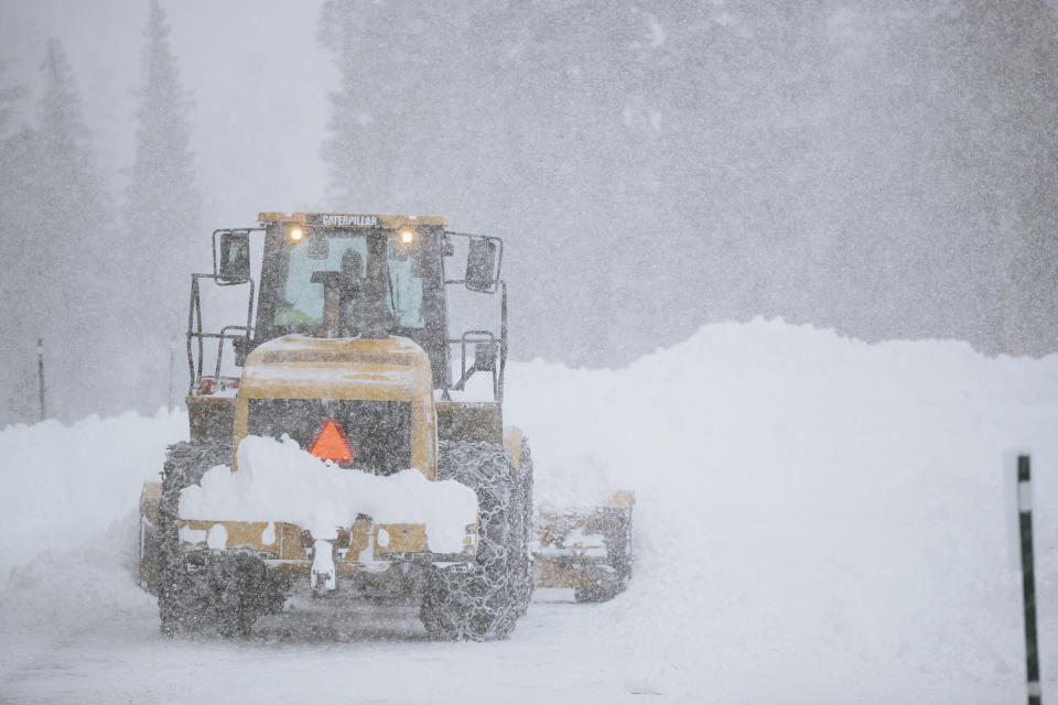 This Tuesday, Nov. 27, 2019 photo provided by the Mammoth Mountain Ski Area shows a Caterpillar snow plow clearing a road at Mammoth Mountain Ski Area resort in Mammoth Mountain, Calif. Blizzard conditions have closed Interstate 5 south of Ashland, Oregon, all the way to the California state line. The Siskiyou Summit at the border on I-5, typically one of the more perilous sections of freeway along the West Coast corridor in wintery weather, had seen 6 inches of new snow with 10 inches packed on the roadside. (Peter Morning/Mammoth Mountain Ski Area via AP)