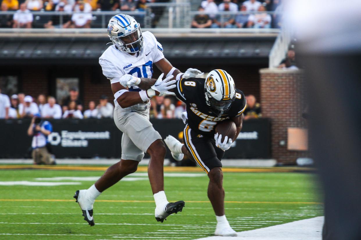 Missouri running back Nathaniel Peat (8) is pushed out of bounds by MTSU's Jakobe Thomas (30) during a game against Middle Tennessee State at Memorial Stadium on Sept. 9, 2023, in Columbia, Mo.