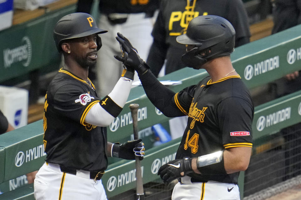 Pittsburgh Pirates' Joey Bart, right, is greeted by Andrew McCutchen as he returns to the dugout after driving in a run with a sacrifice fly off St. Louis Cardinals starting pitcher Miles Mikolas during the fifth inning of a baseball game in Pittsburgh, Wednesday, July 3, 2024. (AP Photo/Gene J. Puskar)