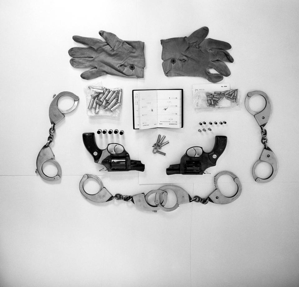 A photo of various articles found by police in the possession of Ian Ball, 26, including handcuffs, two pairs of which are locked together to provide leg shackles, keys for the handcuffs, gloves worn by Ball during the incident, six spent rounds, three live rounds and 39 spares for the .22 gun and a .38 Astra with five spent rounds and 19 spares. The diary belonged to shot PC Michael Hills, with the bullet that pierced it still lodged in his liver. 