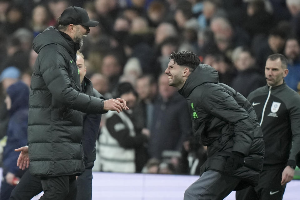 Liverpool's manager Jurgen Klopp, left, celebrates after Liverpool's Virgil van Dijk scored in extra time during the English League Cup final soccer match between Chelsea and Liverpool at Wembley Stadium in London, Sunday, Feb. 25, 2024. (AP Photo/Alastair Grant)