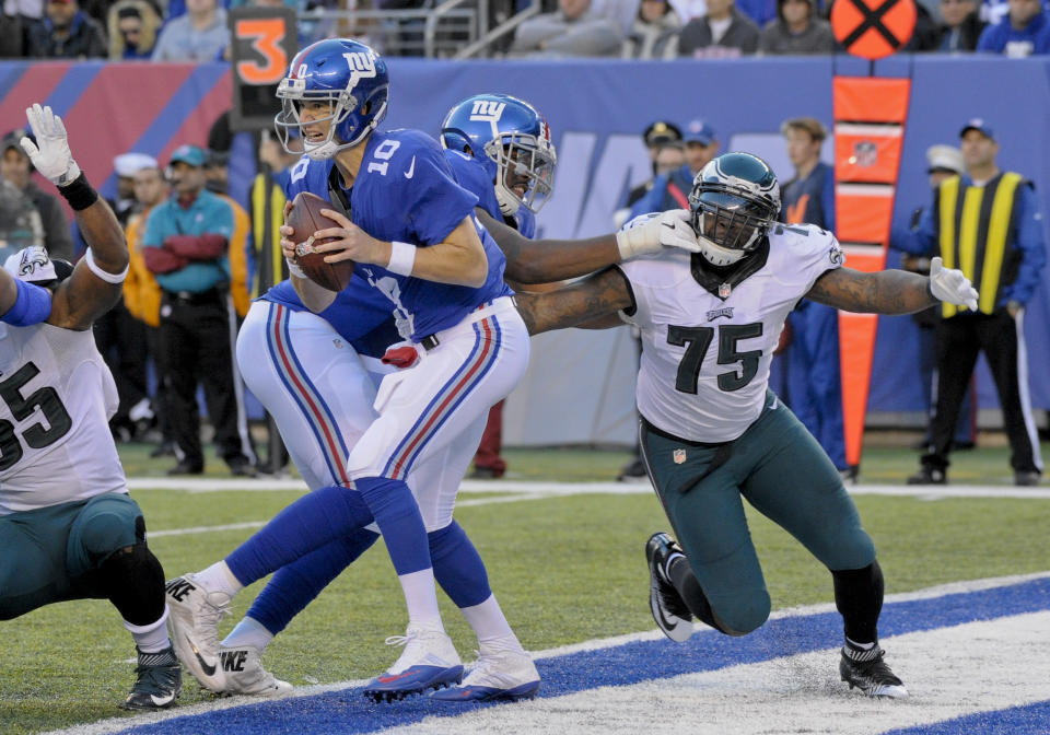 FILE - In this Sunday, Nov. 6, 2016 file photo, New York Giants quarterback Eli Manning (10) moves out of the pocket under pressure from Philadelphia Eagles defensive end Vinny Curry (75) during the fourth quarter of an NFL football game in East Rutherford, N.J. The New York Jets added experience and depth on both sides of the ball with their latest moves in free agency. The team announced Wednesday, March 24, 2021 it signed former Philadelphia Eagles defensive end Vinny Curry, who'll provide an already formidable D-line a veteran pass-rushing presence. The Jets also agreed to terms on a one-year contract with running back Tevin Coleman. (AP Photo/Bill Kostroun, File)