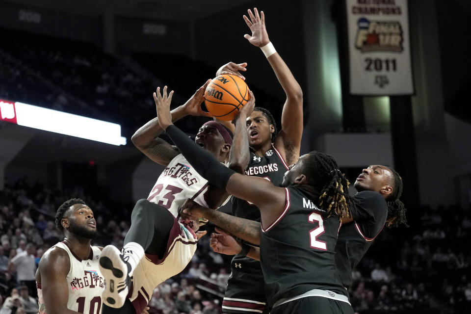 Texas A&M guard Tyrece Radford (23) is knocked to the ground on a foul by South Carolina forward B.J. Mack (2) during the first half of an NCAA college basketball game Wednesday, Feb. 28, 2024, in College Station, Texas. (AP Photo/Sam Craft)