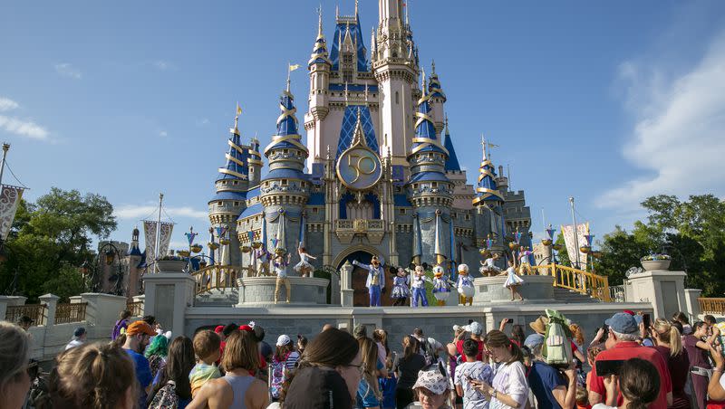 Performers dressed as Mickey Mouse, Minnie Mouse, Goofy, Donald Duck and Daisy Duck entertain visitors at Cinderella Castle at Walt Disney World Resort in Lake Buena Vista, Florida, on April 18, 2022.