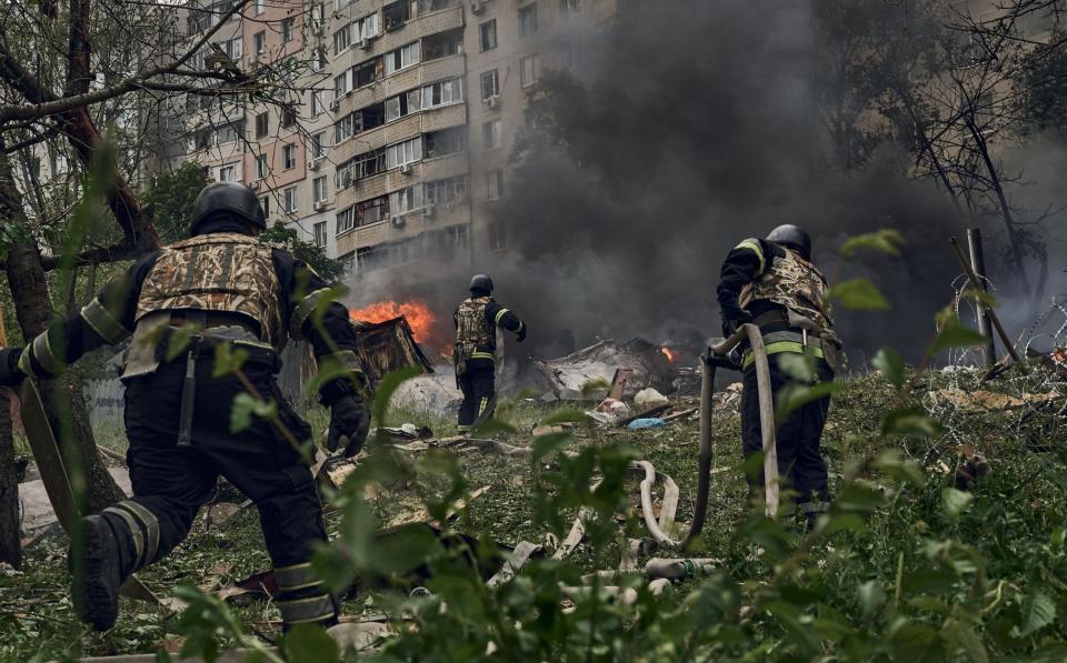 Emergency services fight a fire following a Russian air strike on May 14, 2024 near Kharkiv, Ukraine