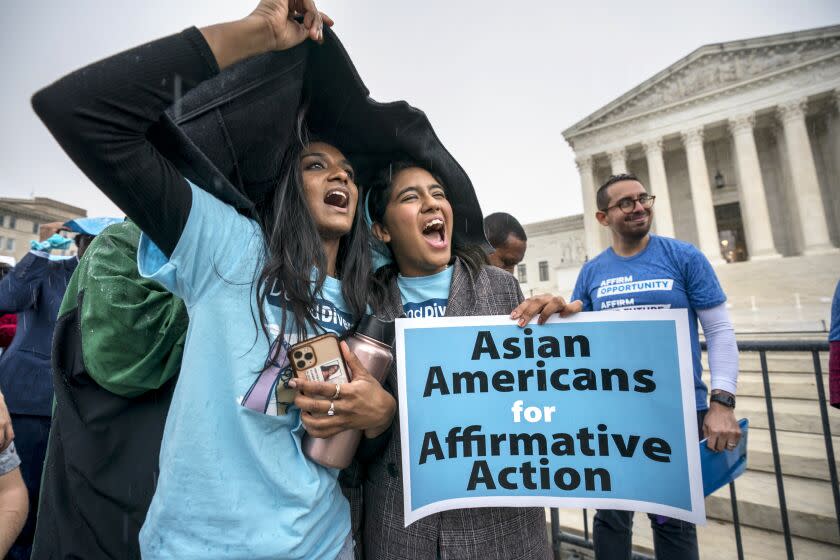 FILE - Harvard students Shruthi Kumar, left, and Muskaan Arshad, join a rally with other activists as the Supreme Court hears oral arguments on a pair of cases that could decide the future of affirmative action in college admissions, in Washington, Monday, Oct. 31, 2022. A new poll from The Associated Press-NORC Center for Public Affairs Research found that 63% of Americans say the Supreme Court should not stop colleges from considering race or ethnicity in their admission systems. (AP Photo/J. Scott Applewhite, File)