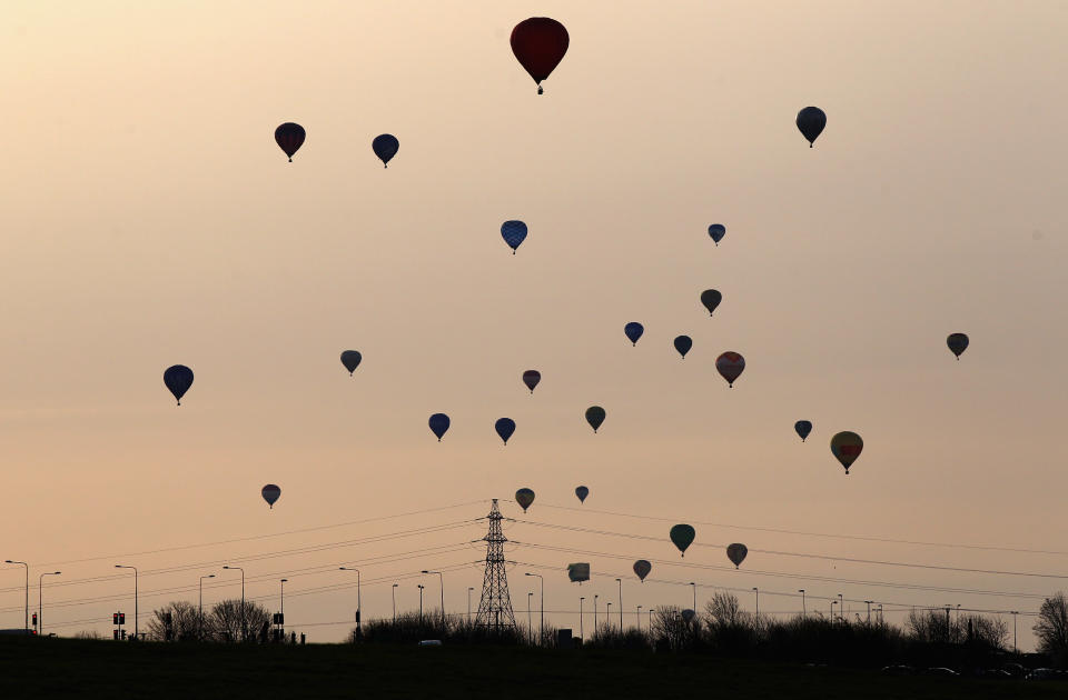 WOOTTON, UNITED KINGDOM - APRIL 07: Hot air balloons depart from Lydden Hill race circuit near Canterbury to take part in a mass crossing of the Channel on April 7, 2011 in Wootton, England. 51 balloonists of various nationalities from across Europe took off from Kent making for Calais, France at about 7am. It is the first time a Guinness World Record bid has been made for "the largest group of hot air balloons to make the Channel crossing". (Photo by Oli Scarff/Getty Images)