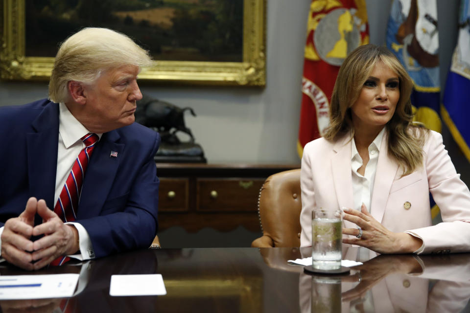 President Donald Trump listens as first lady Melania Trump speaks during a briefing on efforts to combat the opioid crisis in the Roosevelt Room of the White House, Wednesday, June 12, 2019, in Washington. (AP Photo/Alex Brandon)