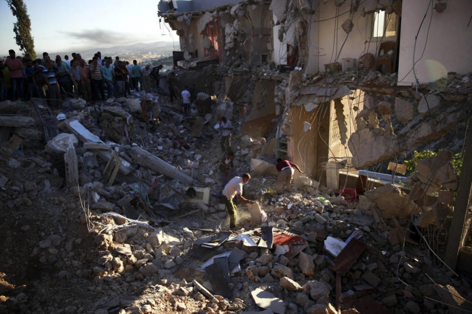 Searching demolished home in Surif 