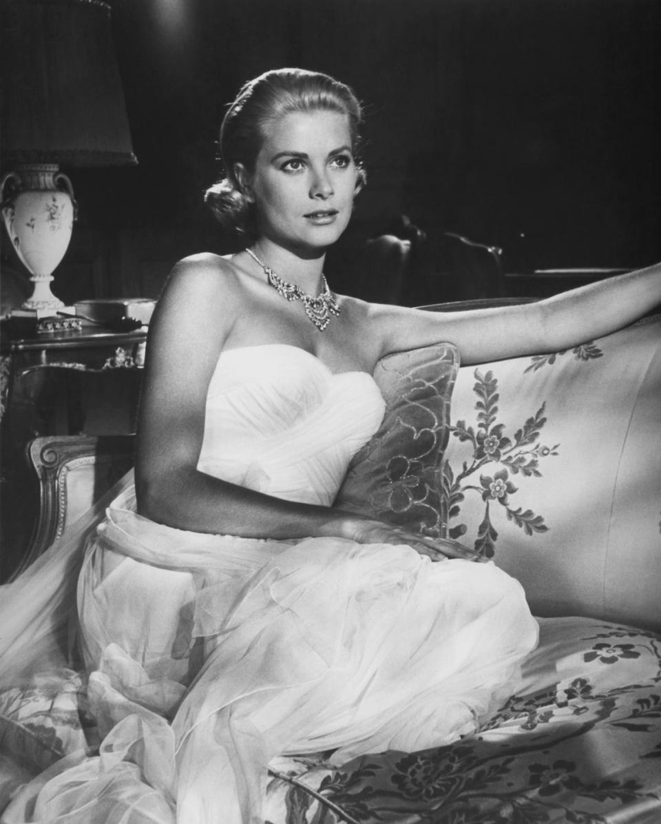 <p>While portraying a wealthy heiress on vacation in the South of France, Grace Kelly managed to look the part in a white strapless chiffon evening gown and diamond necklace that we're sure no jewel thief could resist.</p>